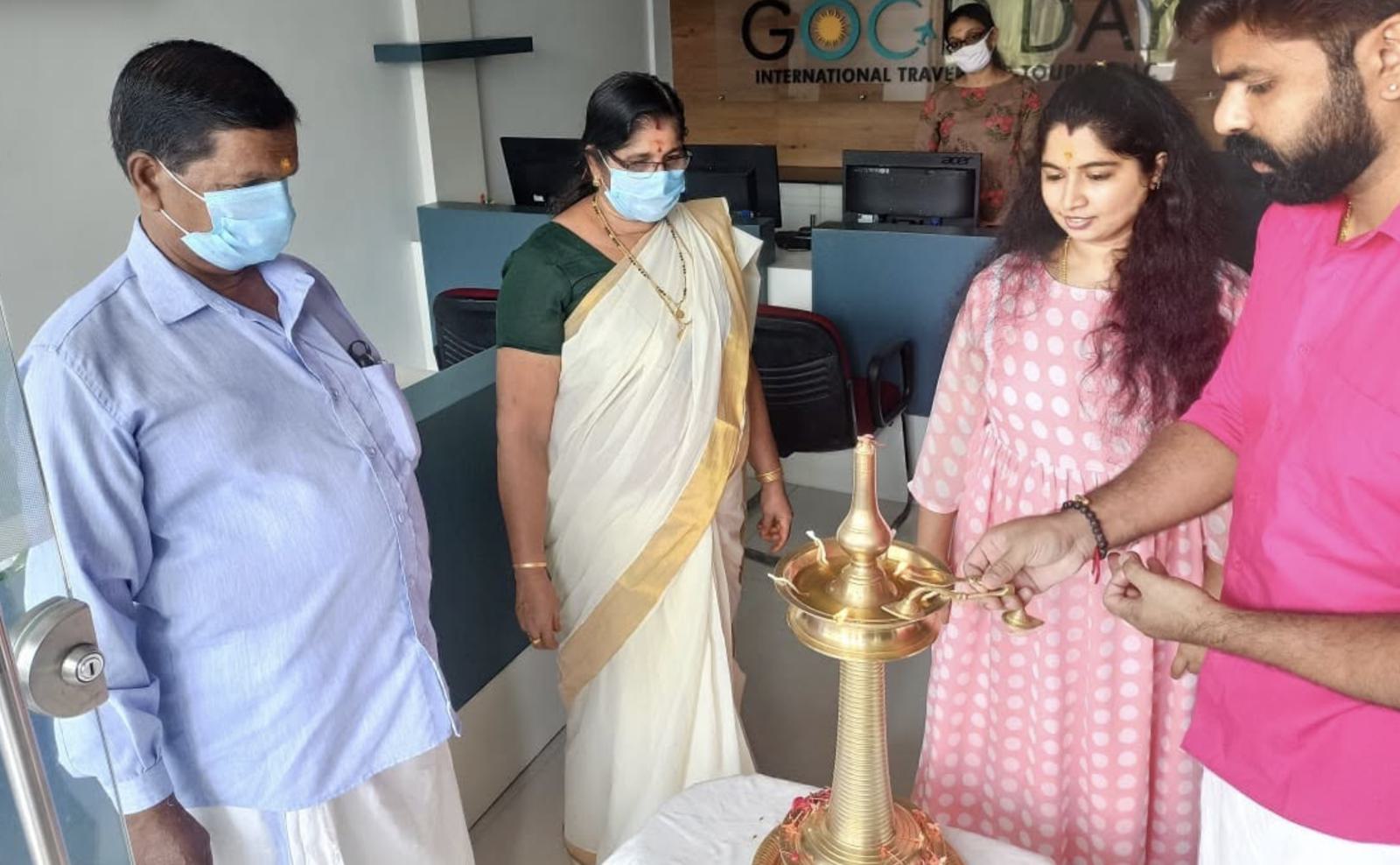 The lamp-lighting inauguration at the GoodDay International Travel & Tourism office in Triprayar, Nattika — the team and guests gathered by the traditional nilavilakku